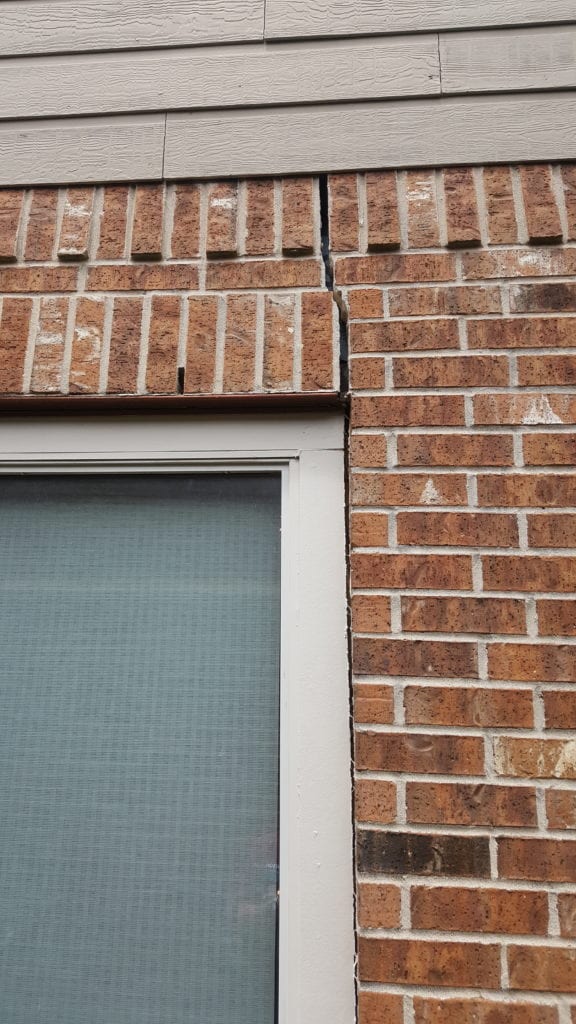 Exterior Warning Sign: Cracked Bricks